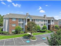 Attractive multi-story condo building featuring manicured landscaping, brick accents, and dedicated parking spaces at 3753 Citation Way # 417, Myrtle Beach, SC 29577