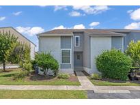 Charming townhome with a well-manicured lawn and blue siding under a bright blue, partly cloudy sky at 4049 Fairway Lakes Dr. # 4049, Myrtle Beach, SC 29577