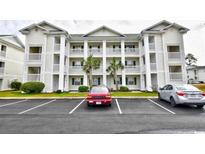 Charming multi-story condo building with white siding, balconies, and well-maintained landscaping at 510 White River Dr. # 24G, Myrtle Beach, SC 29579