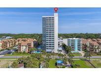 Stunning oceanfront condominium with pools, palm trees, manicured lawns, and panoramic views of the coastline at 5511 N Ocean Blvd. # 1801, Myrtle Beach, SC 29577