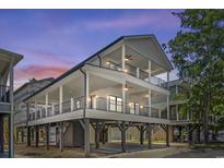Stunning three-story coastal home featuring multi-level covered porches and ample outdoor living space at 6001-Mh13A S Kings Hwy., Myrtle Beach, SC 29575