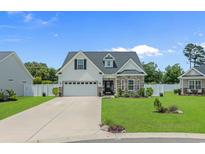 Charming single Gathering home with a manicured lawn and two car garage at 752 Hobonny Loop, Longs, SC 29568