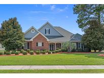 Charming home boasts well-manicured lawn, mature trees, and tasteful landscaping at 904 Kalmia Ct., Myrtle Beach, SC 29579