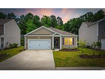 Charming single-story home featuring a one-car garage, manicured lawn, and inviting curb appeal at 1016 Laurens Mill Dr., Myrtle Beach, SC 29579