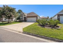 Charming home exterior with stone accents, inviting curb appeal, and a well-maintained lawn at 1301 Camlet Ln., Little River, SC 29566