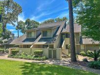 Charming home with a unique architecture, tiled roof, and lush landscaping in a desirable neighborhood at 145 Hartland Dr. # 4-E, Myrtle Beach, SC 29572