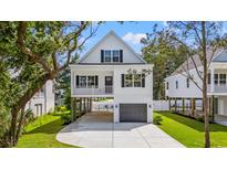 Charming two-story coastal home with a driveway and a garage underneath the main level at 1718 26Th Ave. N, North Myrtle Beach, SC 29582