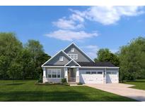 Charming two-story home features a three-car garage, gray siding, and a well-manicured lawn, creating inviting curb appeal at 2285 Hazel Way, Longs, SC 29568