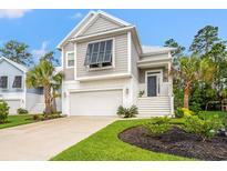 Charming two-story home with a well-manicured lawn, complemented by palm trees and an inviting entrance at 277 Splendor Circle, Murrells Inlet, SC 29576