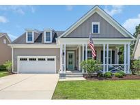 Charming home with a welcoming front porch, attached garage, and manicured lawn at 3005 Purity Place Loop, Murrells Inlet, SC 29576