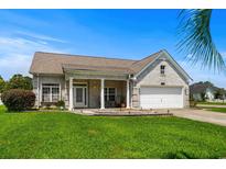 Charming single-story home with a well-manicured lawn and attached two-car garage at 4162 Dupree Dr., Little River, SC 29566