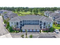 Three-story condo building boasts garages, balconies, and a picturesque golf course view at 4827 Orchid Way # 1-203, Myrtle Beach, SC 29577
