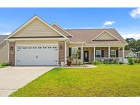 Charming single-story home featuring a two-car garage, inviting front porch, and manicured lawn at 716 Weston Dr., Conway, SC 29526