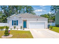 Charming single-story home featuring a teal front door, blue shutters, and a well-manicured lawn at 1074 Sennema Circle, Myrtle Beach, SC 29588