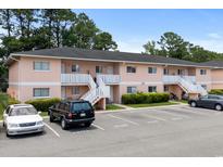 Charming two-story condo building with ample parking and well-maintained landscaping at 1101 2Nd Ave. N # 1501, Surfside Beach, SC 29575
