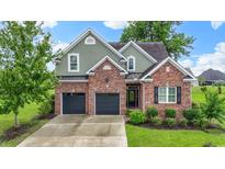 Charming two-story brick home featuring a two-car garage and manicured landscaping at 1106 Bluffton Ct., Myrtle Beach, SC 29579