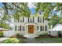 Charming two-story brick home featuring a wood front door, covered porch and mature trees at 126 Cleland St., Georgetown, SC 29440