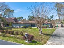 Well-maintained single-story home featuring a lush front lawn, tidy landscaping, and a classic mailbox at 1546 Bay Tree Ln., Myrtle Beach, SC 29575