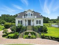 Stately home featuring manicured landscaping, elegant stairways and fountains, plus a rooftop observation deck at 157 Pottery Landing Dr., Conway, SC 29526
