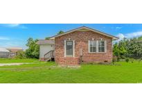 Charming brick home with a well-manicured lawn and inviting front entrance at 175 Cypress Ln., Little River, SC 29566