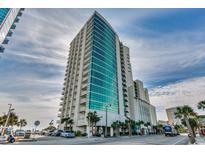 Stunning high-rise condo building with modern design, turquoise glass, and private balconies against a partly cloudy sky at 201 S Ocean Blvd. # 408, Myrtle Beach, SC 29577
