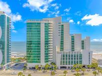 An impressive exterior view of the resort, capturing its multi-story architecture and oceanfront location with palm trees at 201 S Ocean Blvd. # 616, Myrtle Beach, SC 29577