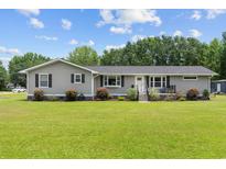 Charming one-story home featuring gray siding, black shutters, and a well-manicured front yard at 241 Fannie B Rd., Conway, SC 29526
