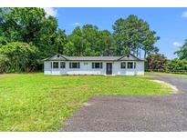 Charming single-story home featuring a well-manicured lawn and lovely landscaping, providing great curb appeal at 4249 E Highway 9, Loris, SC 29569