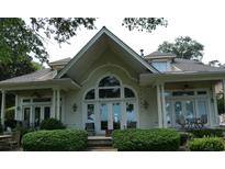 Stunning home featuring a large arch window and inviting outdoor seating area at 4744 Bucks Bluff Dr., North Myrtle Beach, SC 29582