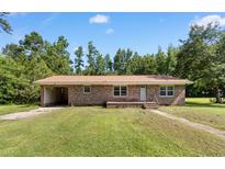 Charming single-story brick home featuring a covered carport and well-maintained lawn at 5 Dogwood St., Hemingway, SC 29554