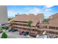 Exterior view of beachside condo with parking, palm trees, and ocean views at 5515 North Ocean Blvd. # 308, Myrtle Beach, SC 29577