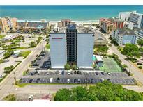 A scenic aerial view of Holiday Towers apartments near the beach showing parking and nearby amenities at 601 Mitchell Dr. # 607, Myrtle Beach, SC 29577