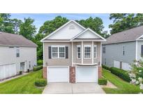Charming home with a two-car garage and well-maintained lawn at 670 2Nd Ave. N, North Myrtle Beach, SC 29582