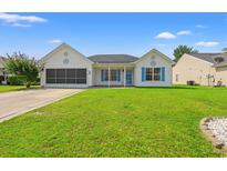 Charming single-story home with a lush green lawn and beautiful blue shutters against a clear blue sky at 708 Alexis Dr., Longs, SC 29568