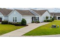 Charming home with well-maintained lawn, neutral siding, dark shutters, and concrete driveway at 754 Salerno Circle # F, Myrtle Beach, SC 29579