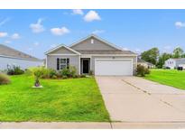 Charming single-story home with a well-manicured lawn, palm tree, and a two-car garage at 821 Twickenham Loop, Longs, SC 29568