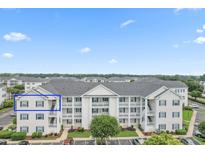 Exterior view of condo building featuring a white facade, balconies and neatly landscaped surroundings at 901 W Port Dr. # 2114, North Myrtle Beach, SC 29582