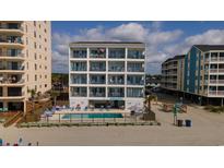 Oceanfront condo building featuring multiple balconies and a shared pool at 920 N Waccamaw Dr. # 2310, Murrells Inlet, SC 29576