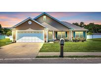 Charming single-story home featuring a manicured lawn, attached garage and inviting front porch at 1036 Macala Dr., Conway, SC 29526