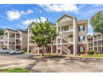 Attractive condo buildings with parking, greenery, brick accents, and welcoming staircases to covered outdoor walkways at 1058 Sea Mountain Hwy. # 102, North Myrtle Beach, SC 29582