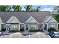 Charming one-story townhome with neutral siding and black trim, surrounded by lush landscaping and convenient parking at 116 Kingsbury Loop # C, Conway, SC 29526