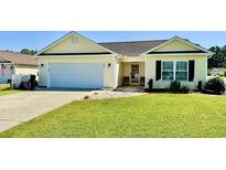 Charming single-story home featuring a manicured lawn, attached garage, and inviting front entrance at 1300 Ruddy Ct., Conway, SC 29527