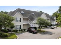 Charming condo exterior with multiple levels, white stairs, and a well-maintained parking area at 134 Scotch Broom Dr. # K - 201, Little River, SC 29566