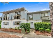 Charming two-story townhouse with a well-maintained and inviting front yard at 1809 Crooked Pine Dr. # G3, Surfside Beach, SC 29575