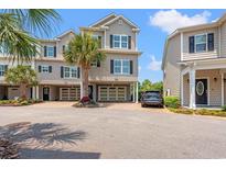 Attractive townhomes with garages, manicured landscaping, and convenient parking enhance the curb appeal at 1907 Enclave Ln. # 1907, North Myrtle Beach, SC 29582