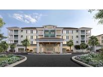 Elegant condominium exterior with tropical landscaping, covered entrance, and decorative architectural details at 235 Fins Up Circle # 1-102, Myrtle Beach, SC 29572