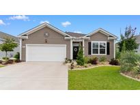 Charming home exterior with a well-manicured lawn and landscaping, highlighting its curb appeal and welcoming entrance at 2438 Polaris Path, Myrtle Beach, SC 29577