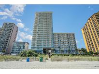 Stunning oceanfront condo building featuring numerous balconies overlooking a sandy beach on a bright sunny day at 2504 N Ocean Blvd. # 936, Myrtle Beach, SC 29577