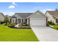 Charming single-story home with manicured lawn, lush landscaping, and a two-car garage at 2783 Sanctuary Blvd., Conway, SC 29526