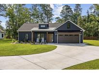 Charming single-story home featuring a well-manicured lawn and a spacious driveway at 4446 Boggy Rd., Conway, SC 29526